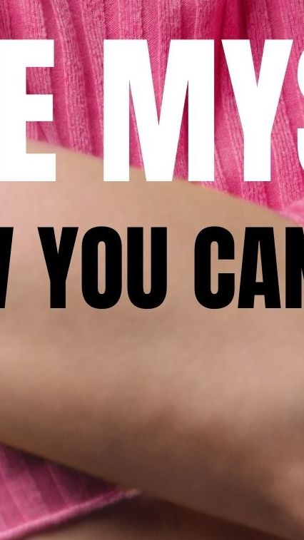 Image of a female in a pink sweater hugging herself.